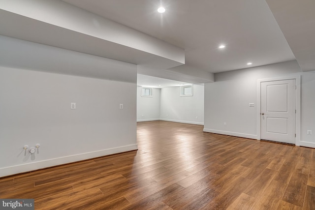 finished below grade area with wood finished floors, baseboards, and recessed lighting