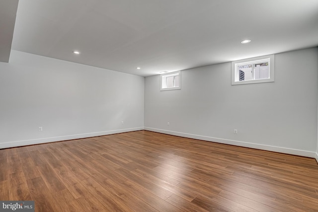 below grade area featuring recessed lighting, baseboards, and wood finished floors