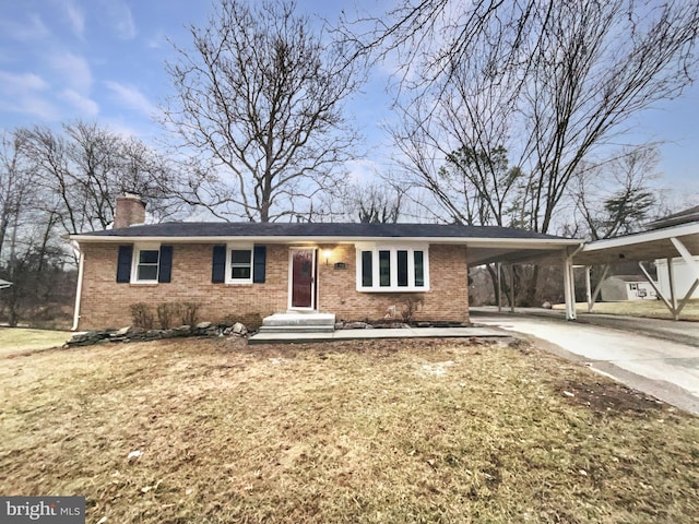 ranch-style house featuring brick siding, an attached carport, driveway, and a chimney