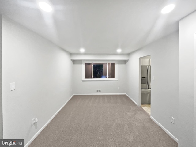 unfurnished room featuring recessed lighting, visible vents, baseboards, and light carpet