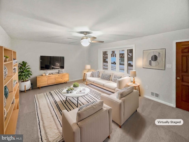 living area with visible vents, carpet flooring, baseboards, and ceiling fan