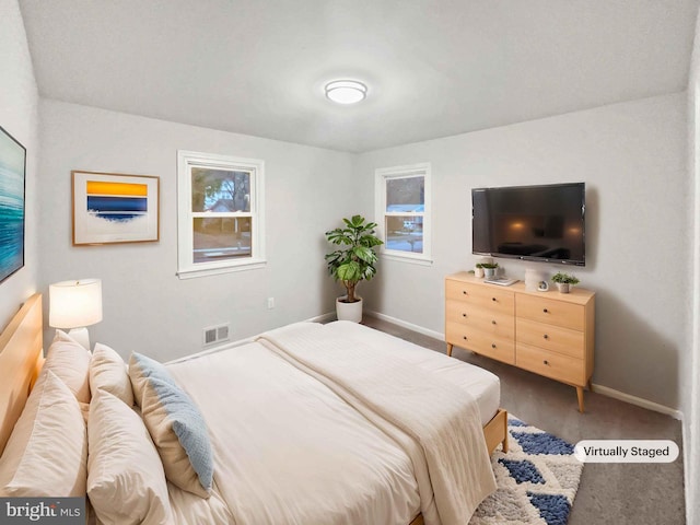 bedroom with visible vents, baseboards, and carpet