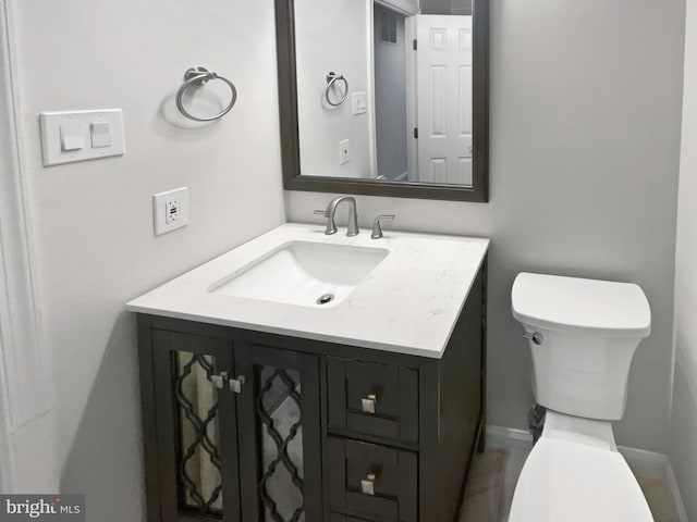 bathroom featuring vanity and toilet