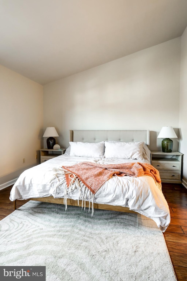 bedroom with wood finished floors and baseboards