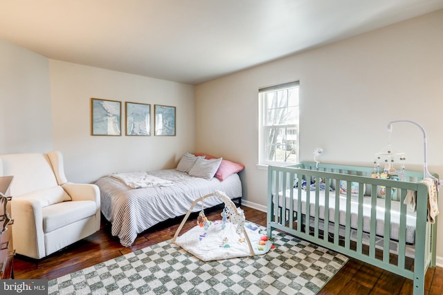 bedroom with baseboards and wood-type flooring