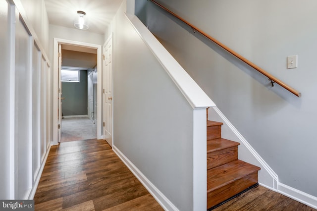 stairway featuring baseboards and wood finished floors