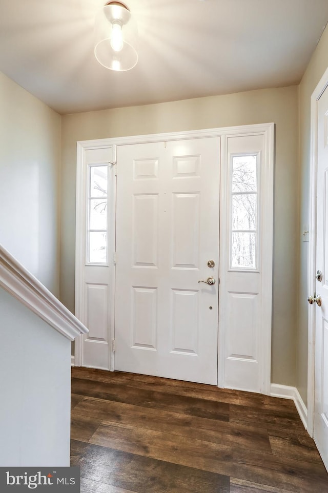 foyer entrance with dark wood finished floors