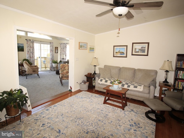 living room with wood finished floors, crown molding, ceiling fan, and vaulted ceiling