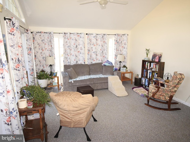 carpeted living room featuring lofted ceiling, baseboards, and ceiling fan