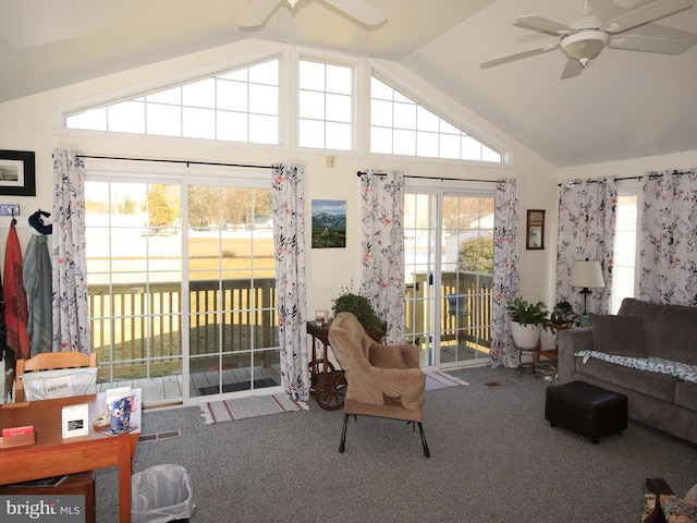 living room with carpet flooring, a ceiling fan, and vaulted ceiling