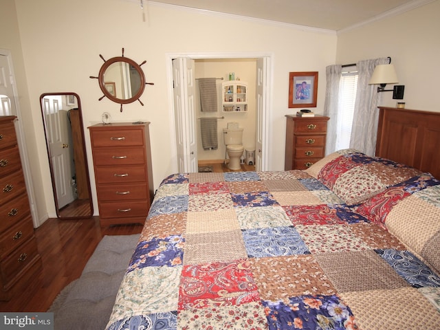 bedroom featuring ensuite bath, ornamental molding, dark wood-style flooring, and vaulted ceiling