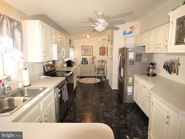 kitchen featuring a sink, vaulted ceiling, light countertops, appliances with stainless steel finishes, and white cabinetry