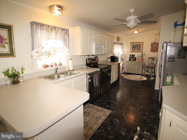 kitchen featuring white cabinets, stainless steel appliances, light countertops, and a sink