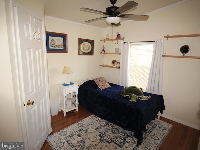 bedroom with ceiling fan, baseboards, wood finished floors, and crown molding