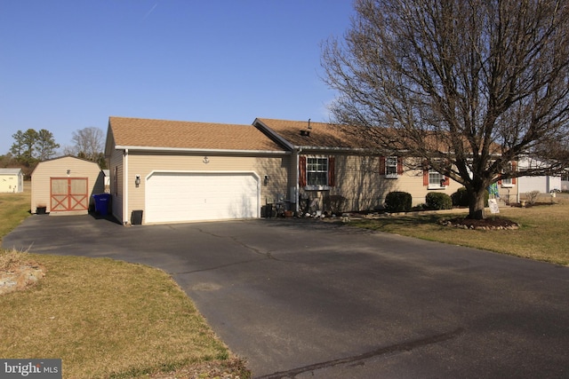 ranch-style house with an attached garage, a front lawn, and a shingled roof