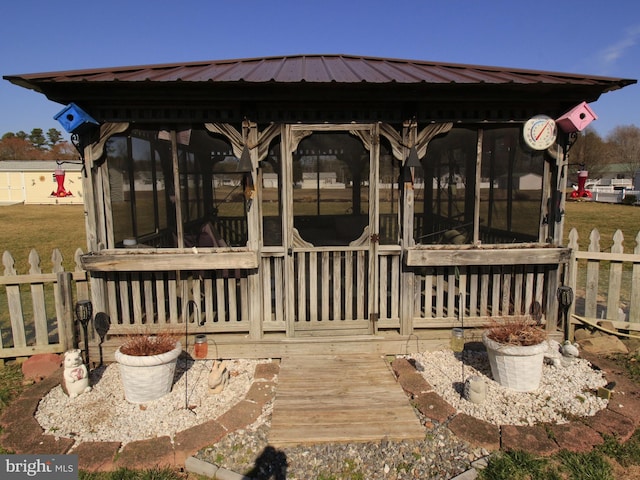 deck featuring fence and a sunroom