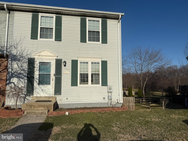 view of front of house with a front yard and fence