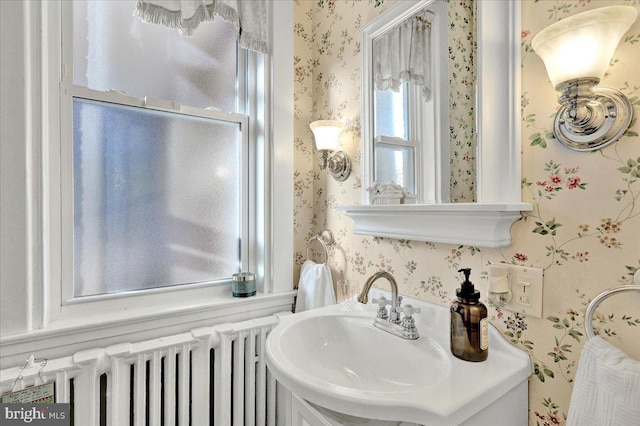 bathroom featuring wallpapered walls and radiator heating unit