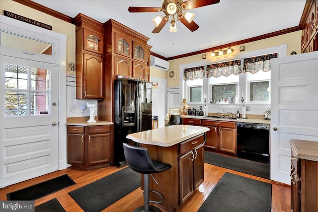 kitchen featuring ceiling fan, light countertops, a wall unit AC, ornamental molding, and black appliances