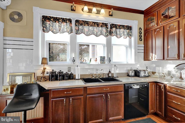 kitchen with visible vents, dishwasher, light countertops, decorative backsplash, and a sink