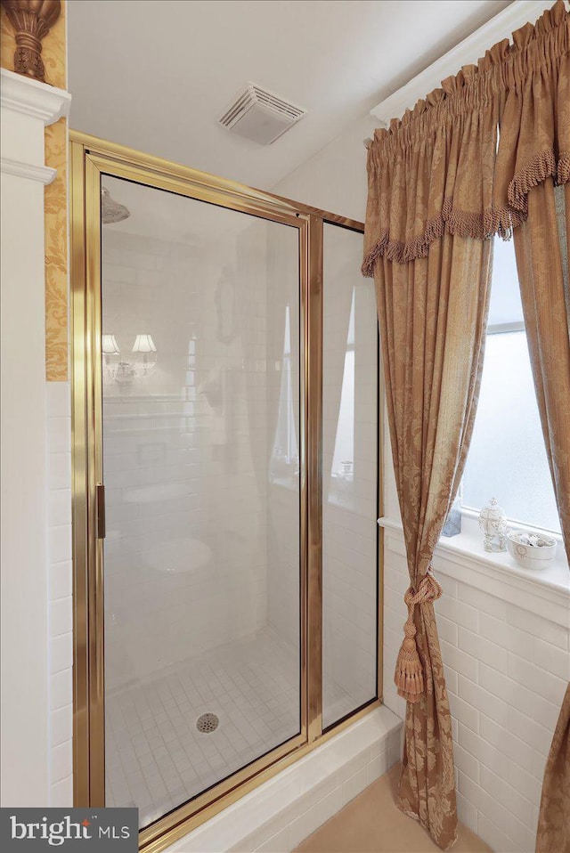 bathroom featuring visible vents and a shower stall