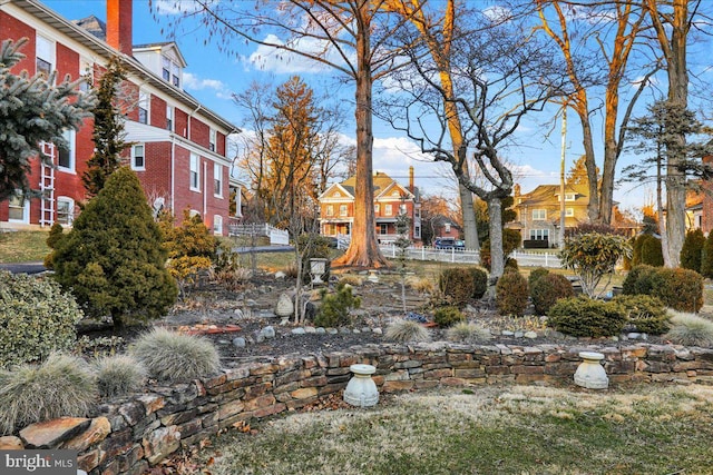 surrounding community with fence and a residential view