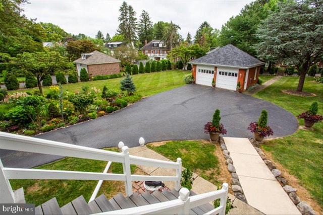 view of yard featuring an outbuilding, fence, and a detached garage