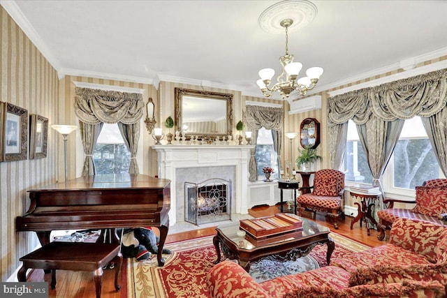 living area with a wealth of natural light, a notable chandelier, and wallpapered walls