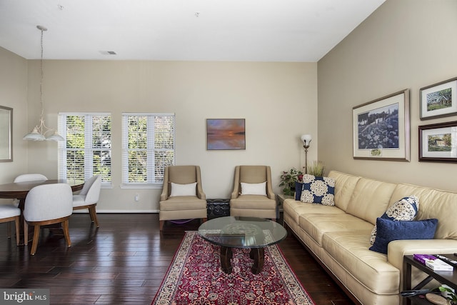 living room featuring visible vents, baseboards, and dark wood-style flooring