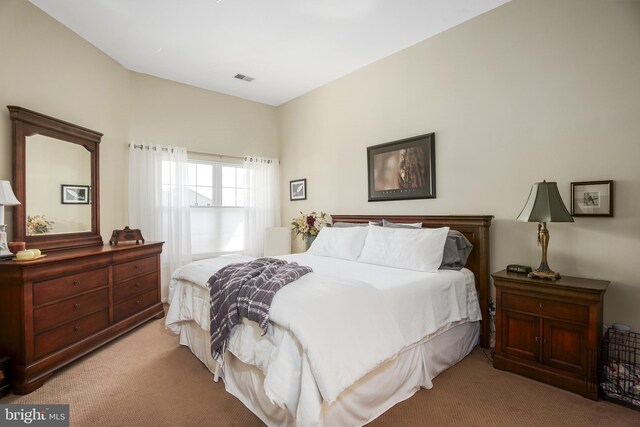 carpeted bedroom featuring visible vents