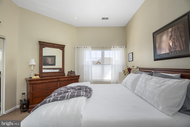 carpeted bedroom featuring visible vents and baseboards