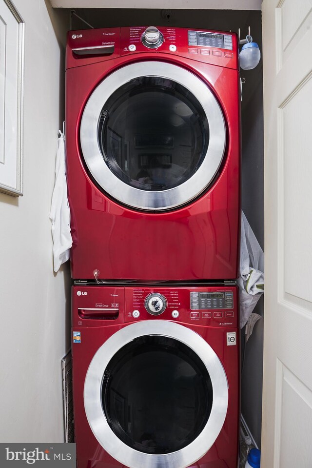 washroom featuring laundry area and stacked washer / dryer