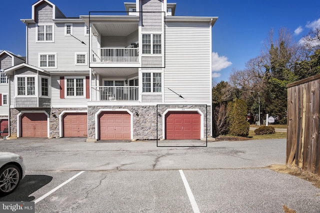 exterior space with a garage and a balcony