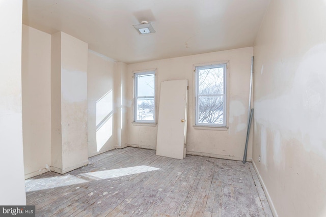 spare room with hardwood / wood-style floors