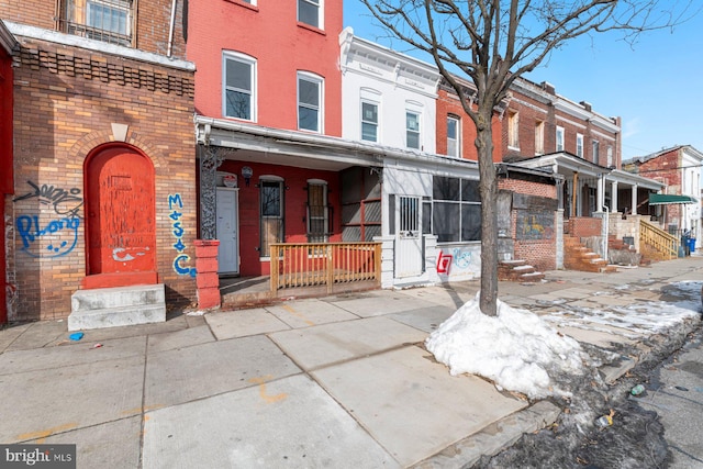 property entrance featuring brick siding