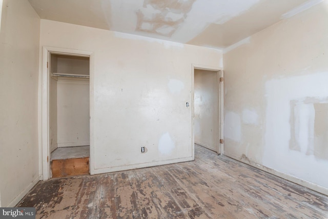 unfurnished bedroom featuring wood finished floors and a closet