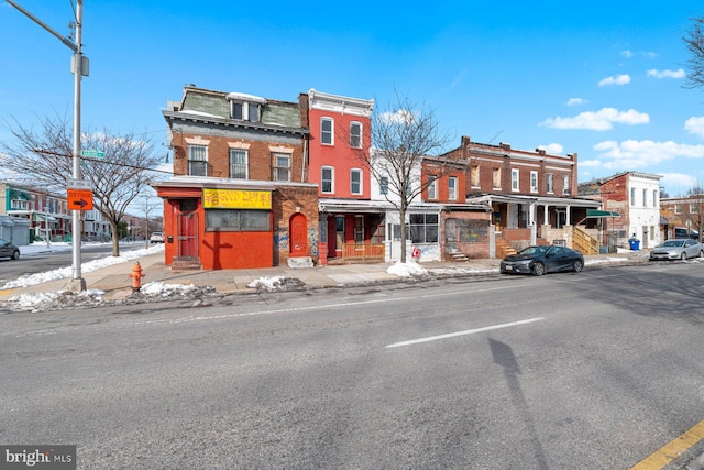 view of front facade featuring brick siding and mansard roof