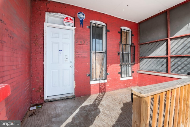 property entrance with brick siding