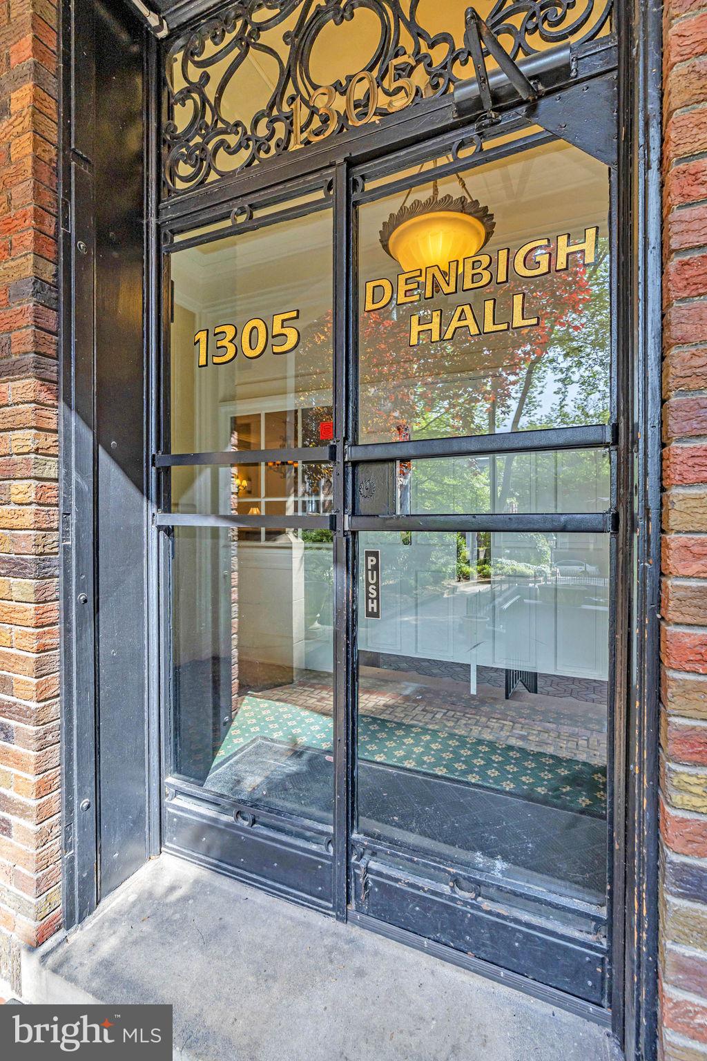 doorway to property featuring brick siding