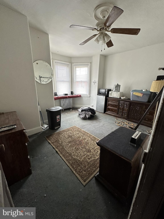 interior space featuring a ceiling fan and baseboards