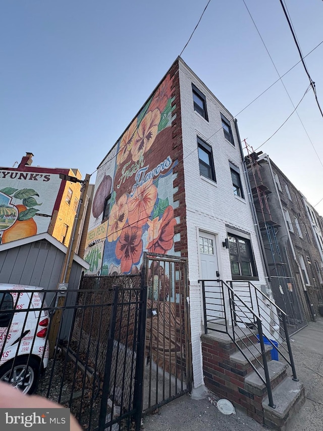 view of building exterior with fence