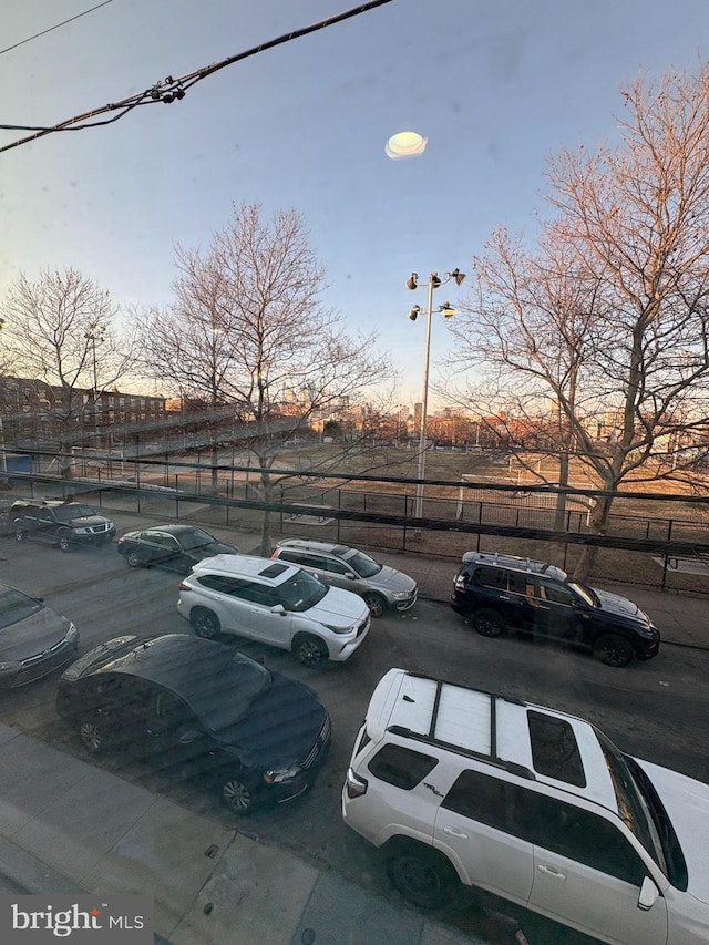 view of car parking featuring fence