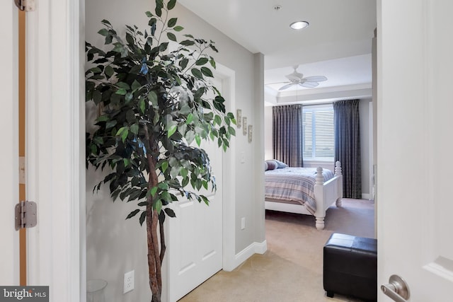 bedroom featuring light carpet and baseboards