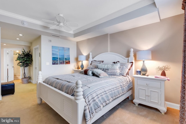 bedroom featuring light carpet, a ceiling fan, a tray ceiling, recessed lighting, and baseboards