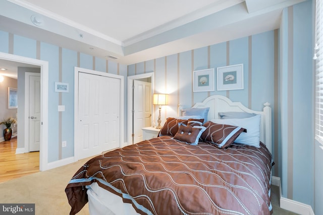 bedroom featuring visible vents, a closet, carpet flooring, wallpapered walls, and baseboards