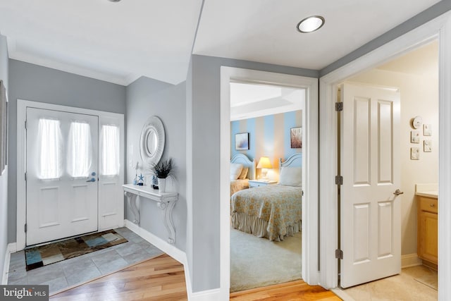 foyer entrance featuring baseboards and light wood finished floors