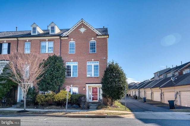 townhome / multi-family property with community garages and brick siding