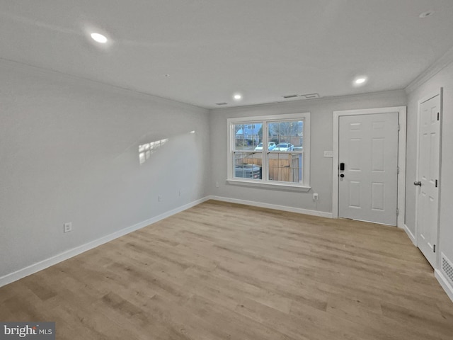 foyer with crown molding, recessed lighting, light wood-style floors, and baseboards