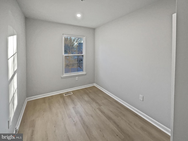 unfurnished room featuring recessed lighting, visible vents, baseboards, and wood finished floors