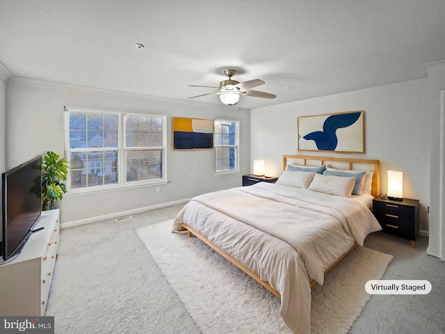 carpeted bedroom with visible vents, ceiling fan, and baseboards